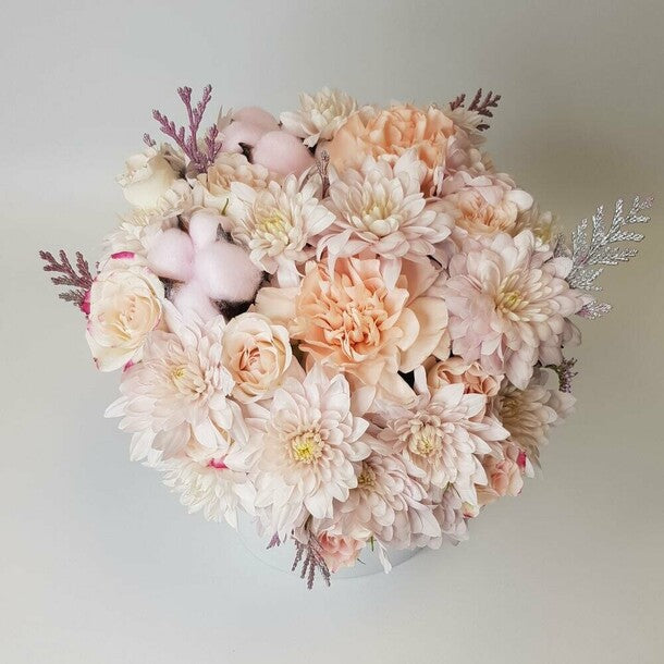 Flowers in a white box. A delicate pastel arrangement with diantus, cotton, and chrysanthemum