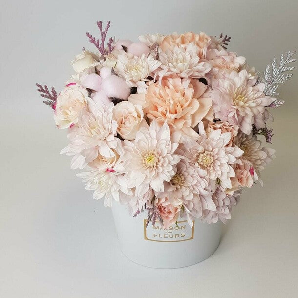 Flowers in a white box. A delicate pastel arrangement with diantus, cotton, and chrysanthemum