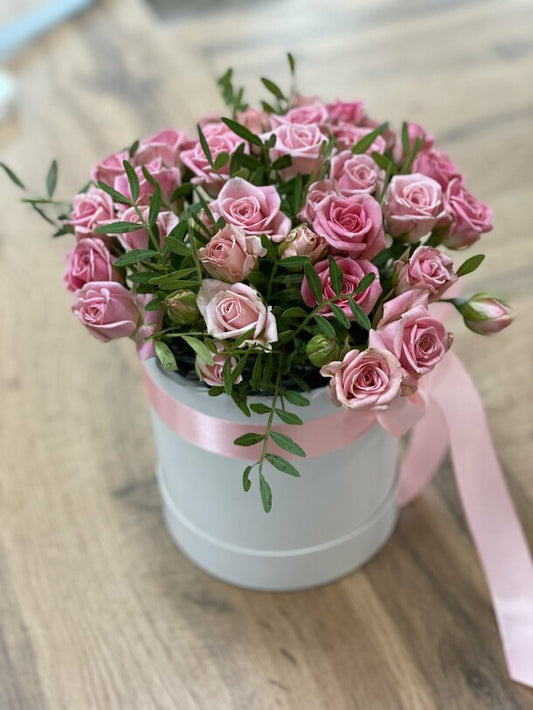 11 pink bush roses in a box