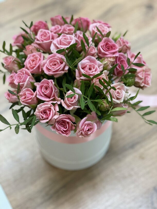 11 pink bush roses in a box