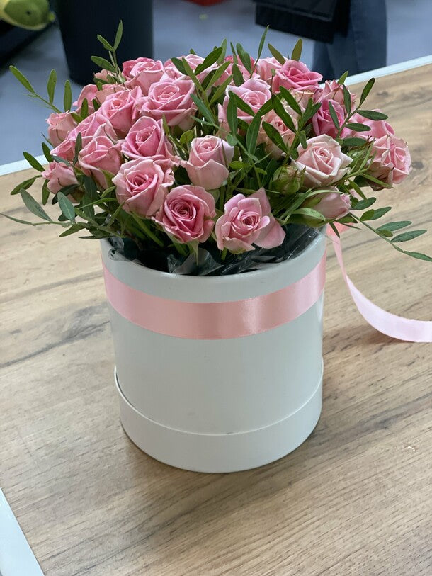 11 pink bush roses in a box