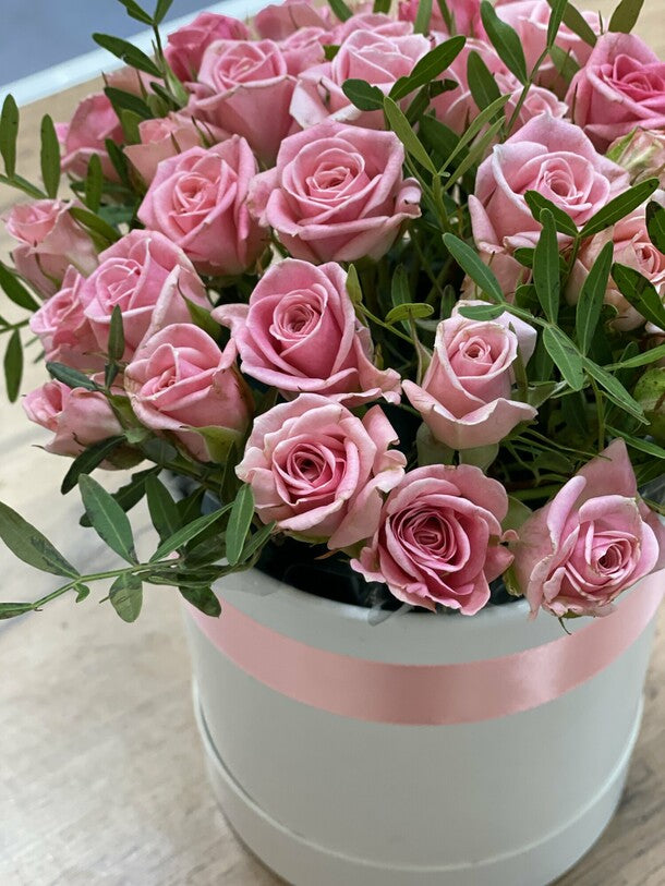 11 pink bush roses in a box