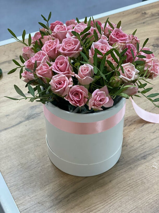 11 pink bush roses in a box