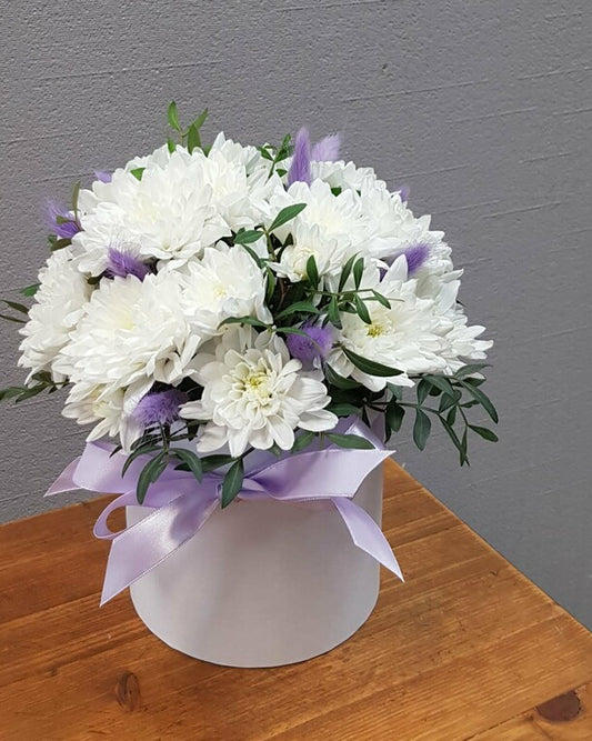 A box with a white bush chrysanthemum and a "present" lagurus