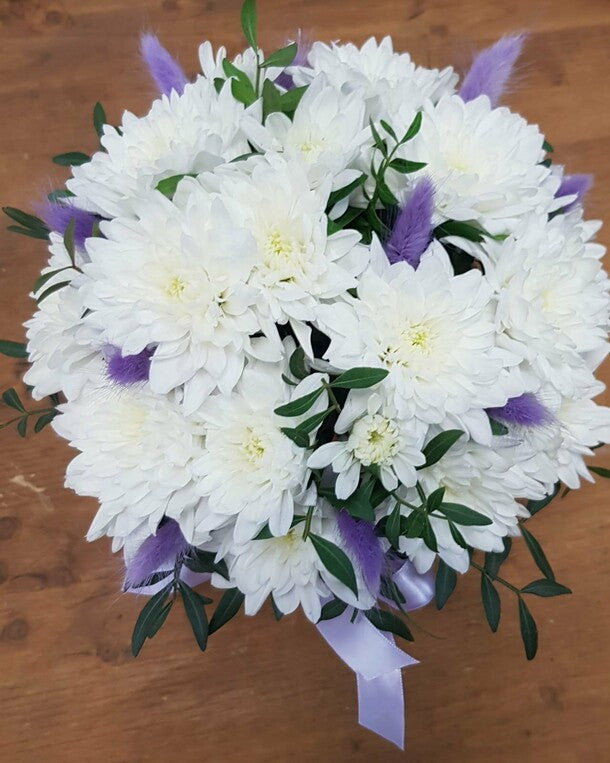 A box with a white bush chrysanthemum and a "present" lagurus