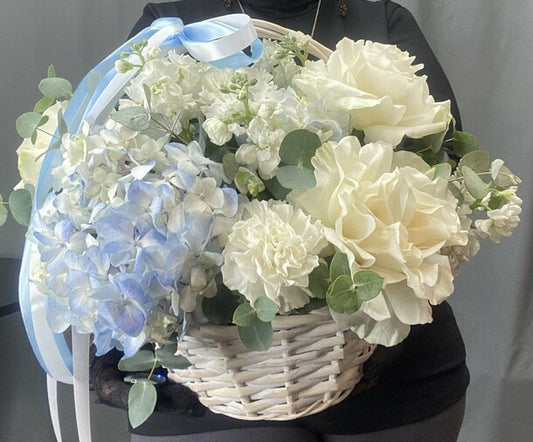Hydrangeas and French roses in a basket