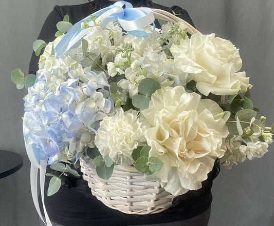 Hydrangeas and French roses in a basket