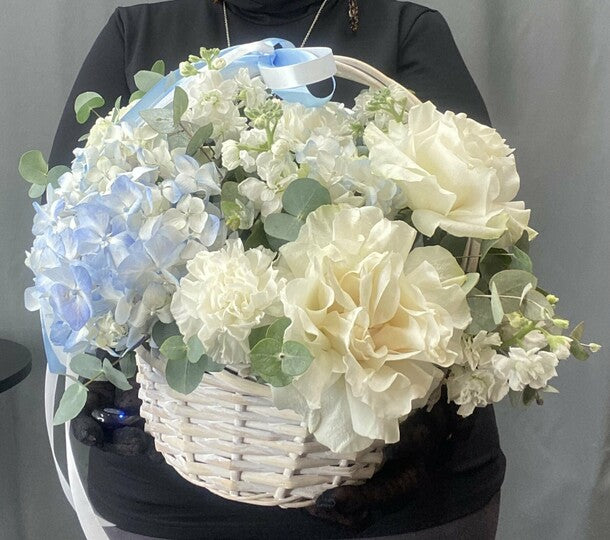 Hydrangeas and French roses in a basket