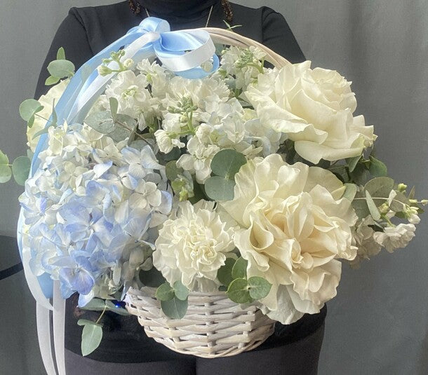Hydrangeas and French roses in a basket